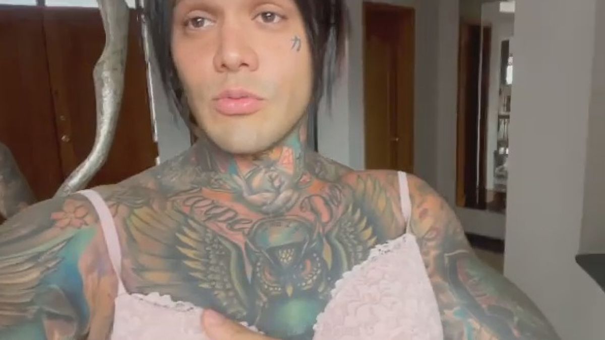 Tattooed man shows off breast implants after waging bet to reach ...