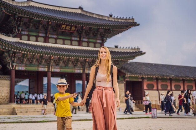 Premium Photo | Mom and son tourists in korea gyeongbokgung palace ...