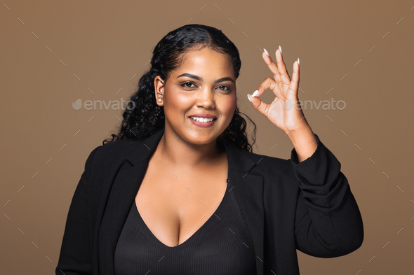 Positive chubby brazilian woman showing okay gesture and smiling ...
