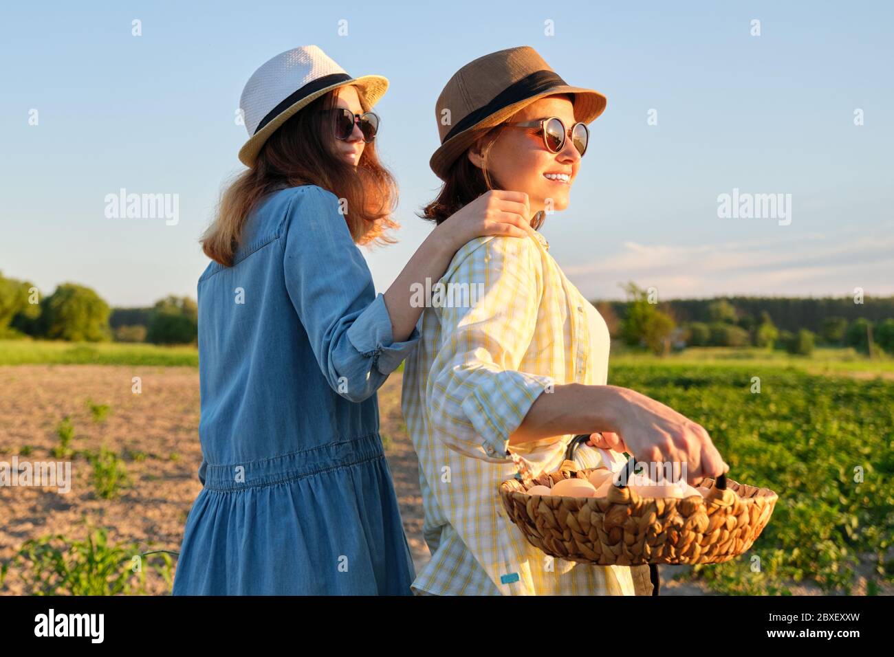 Women mother and daughter with basket of eggs, lifestyle, nature ...