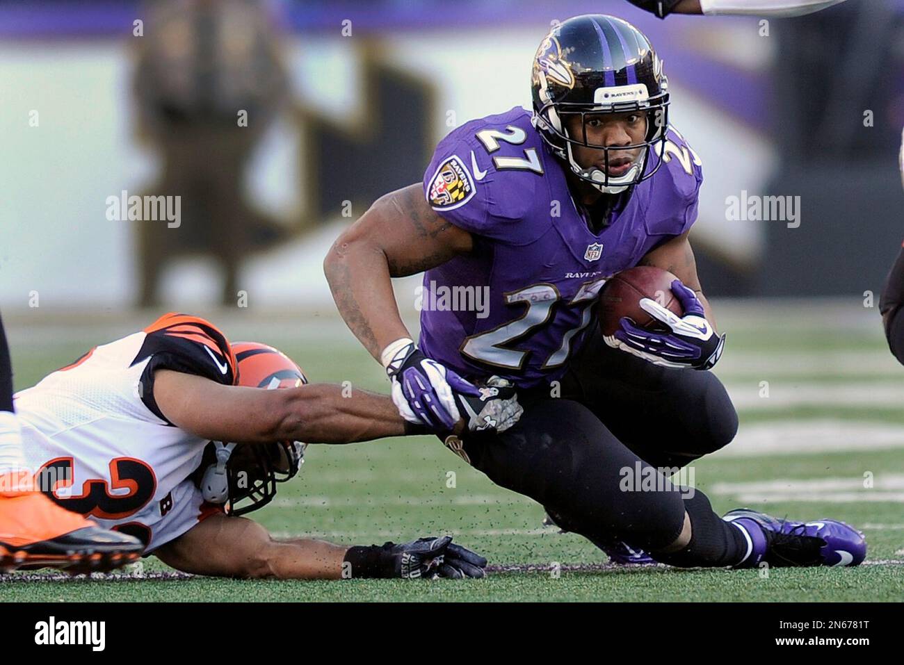 Baltimore Ravens running back Ray Rice is dragged to the turf by ...