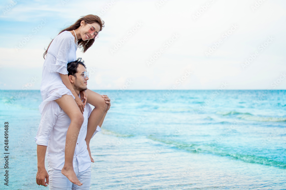 Young asian couple in love honeymoon at sea beach on blue sky ...