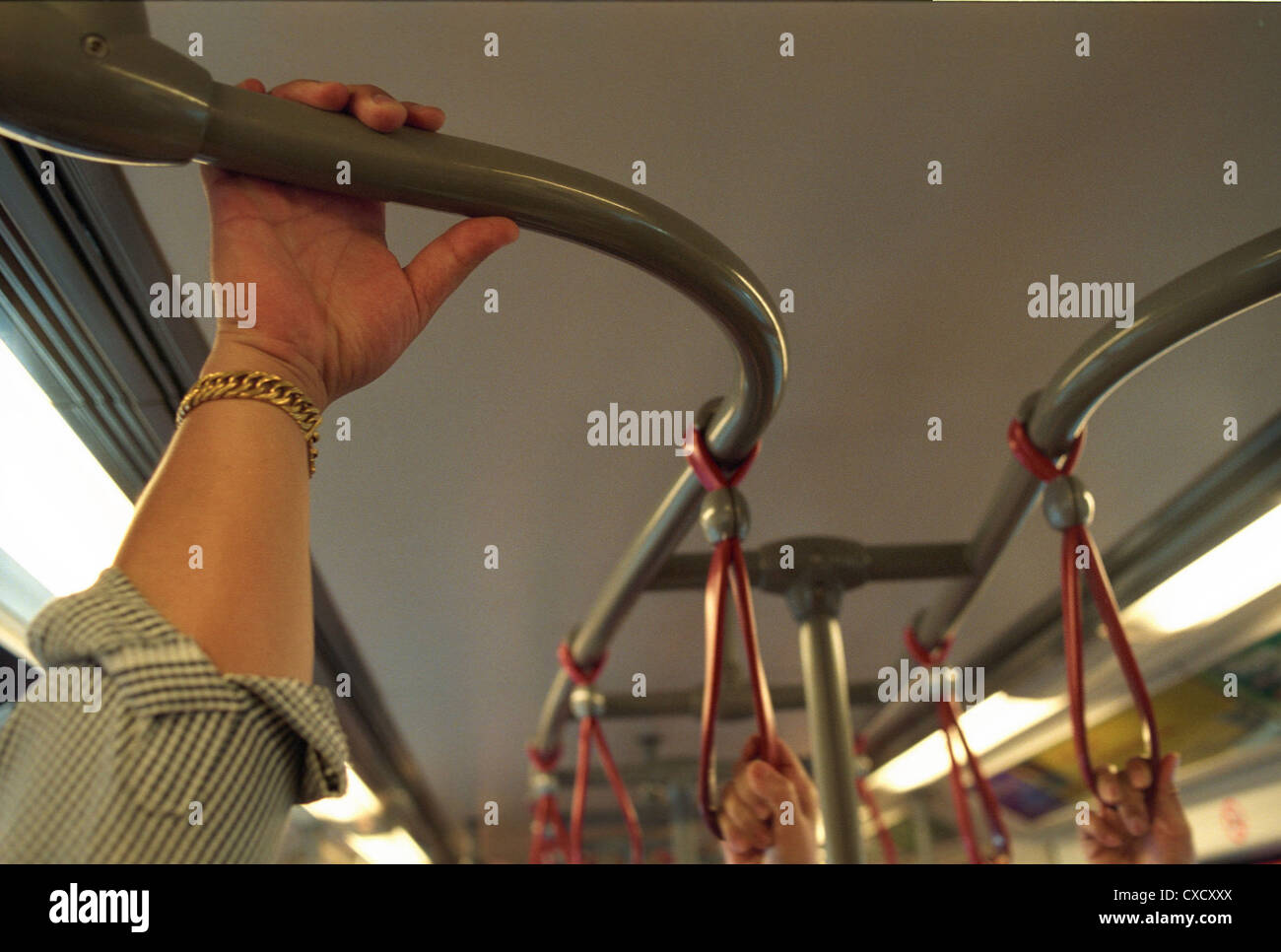 Bangkok, a Maennerhand holds tight to a fixture in the Skytrain ...