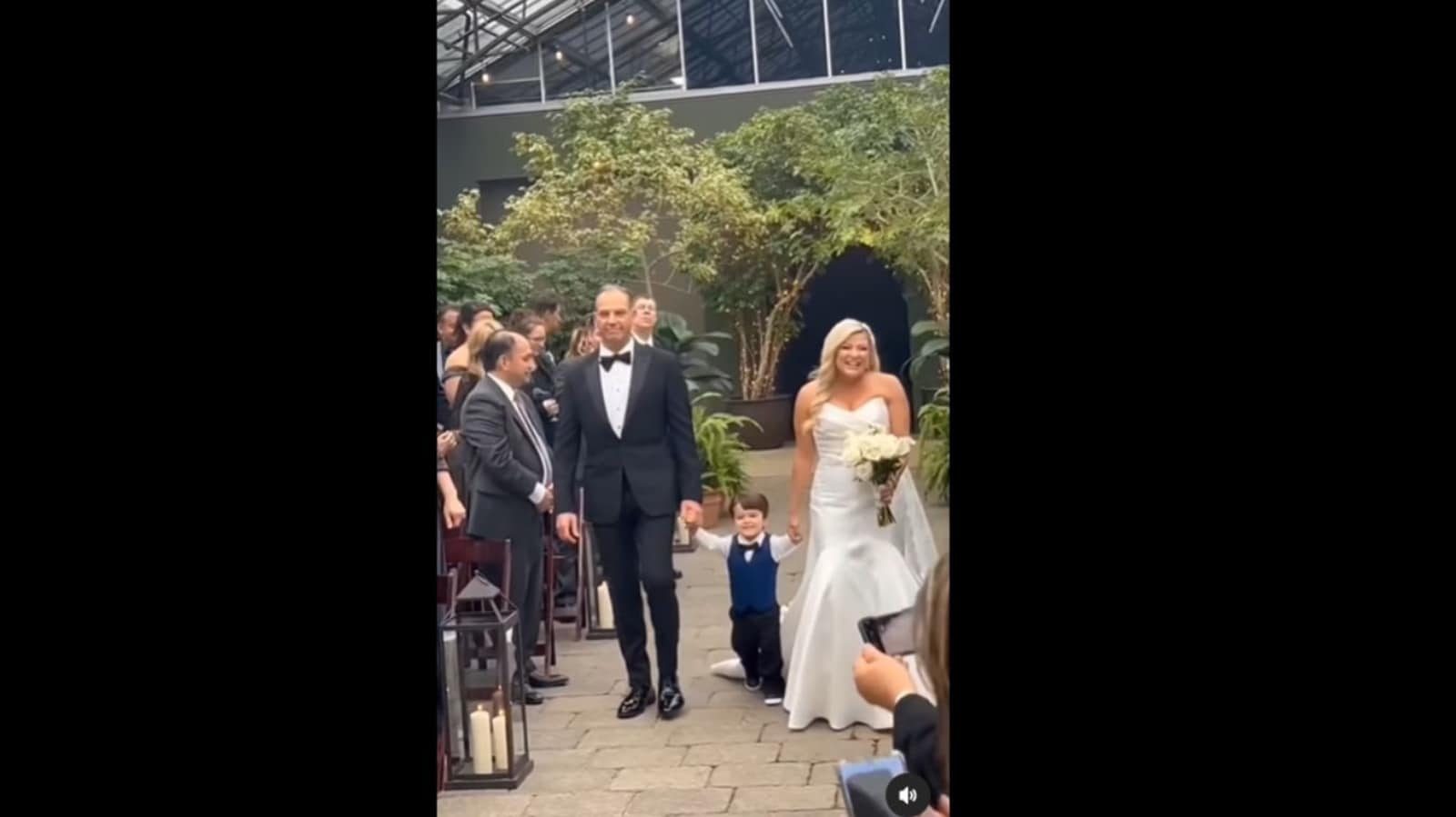 Son runs over to mom when he sees her walking down the aisle ...