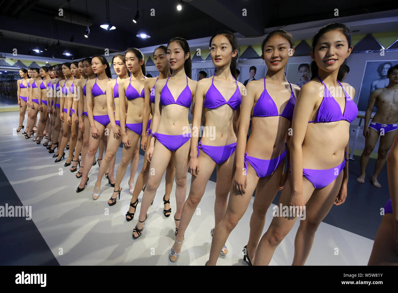 Bikini-clad young female Chinese students take part in a model ...