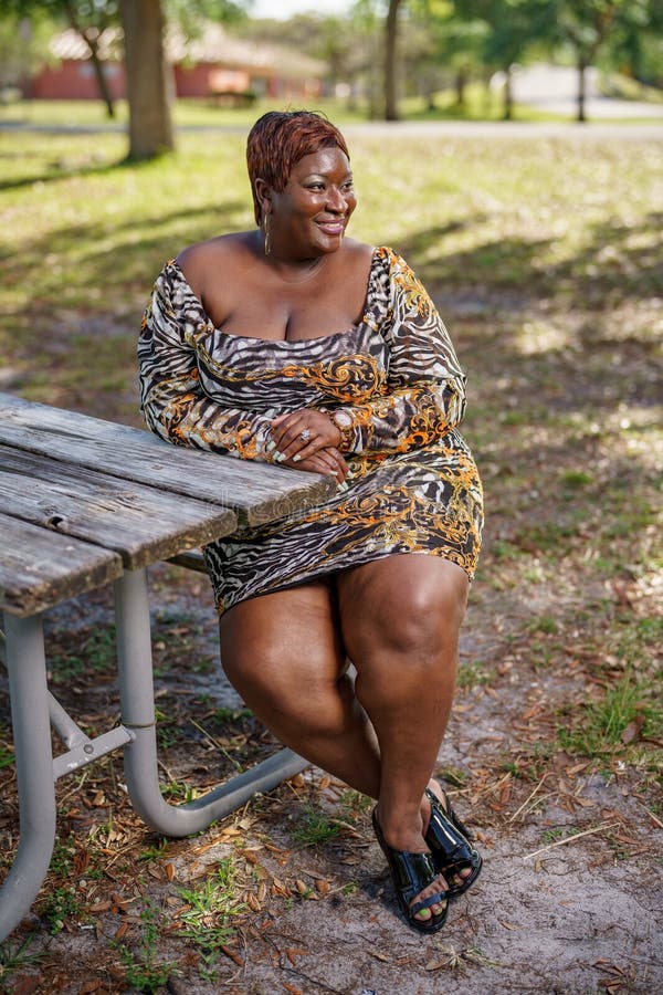 BBW Big Black Beautiful Model Sitting on a Park Bench Outdoors ...