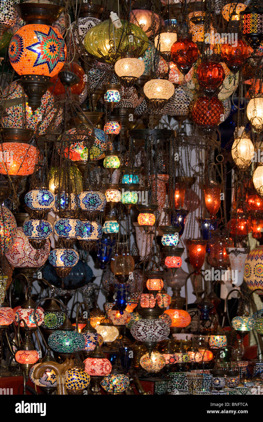 A stall of colourful mosaic glass lampshades with black wrought ...