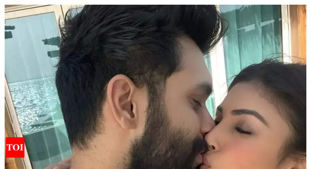 Mouni Roy shares a romantic kiss with her husband Suraj Nambiar as ...