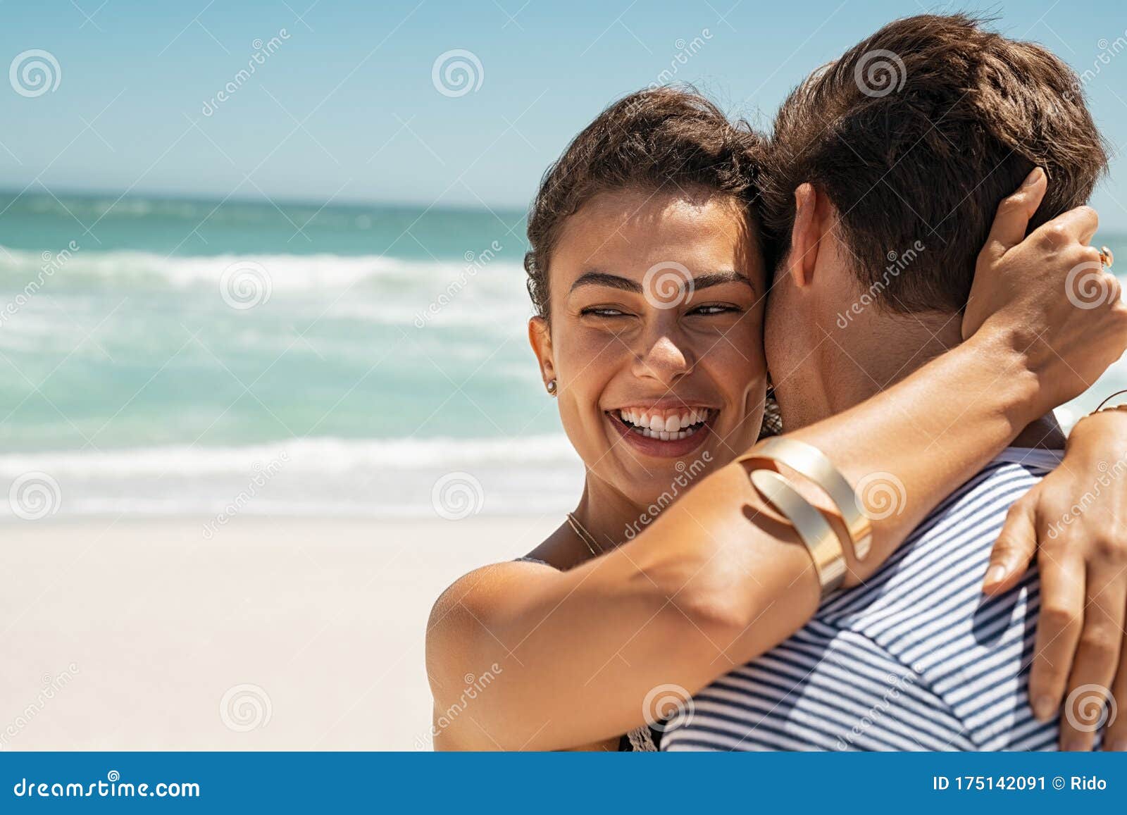 Happy Woman Embracing Her Boyfriend at Beach Stock Image - Image ...