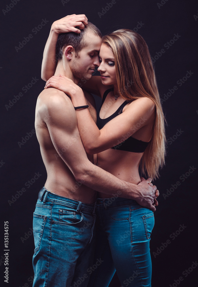 Sexy couple in jeans. Boyfriend and girlfriend embracing in the ...