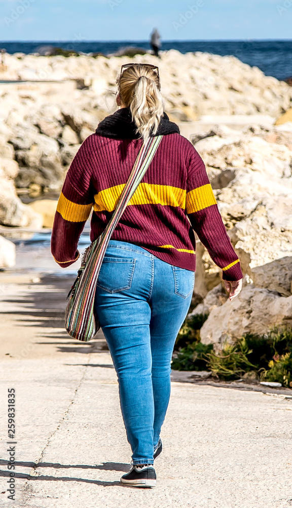 Woman with big booty in jeans walking down the street Stock Photo ...