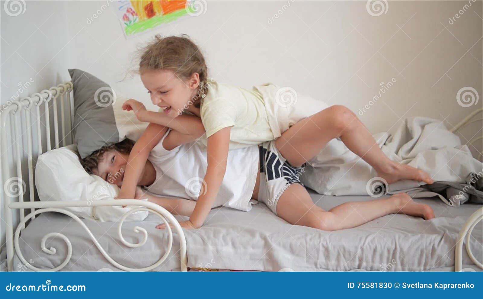 Boy Throws a Pillow at the Girl Who Sleeps, Happy Laughing Brother ...