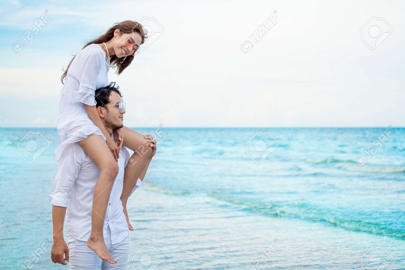 Young Asian Couple In Love Honeymoon At Sea Beach On Blue Sky ...