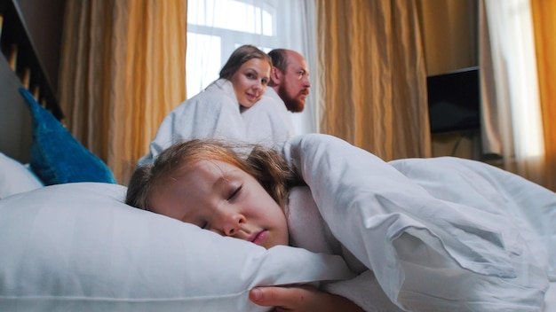 Premium Photo | A family in the hotel room a little girl sleeping ...