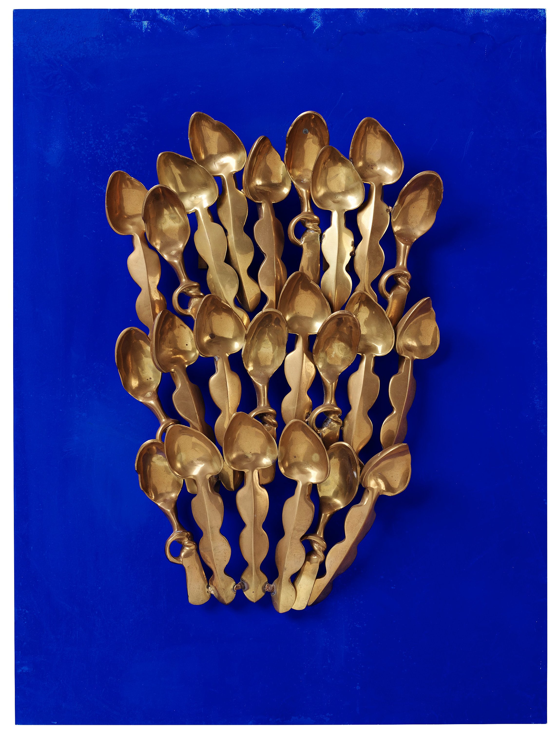 Arman, polished bronze mounted on Klein blue wooden panel, signed ...