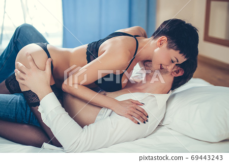 Emotional sexy scene young woman undressing her... - Stock Photo ...