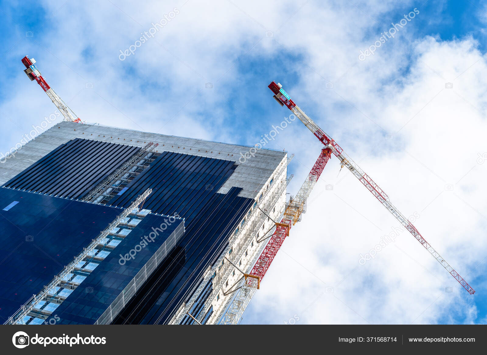 Low angle view of office building under construction in the city ...