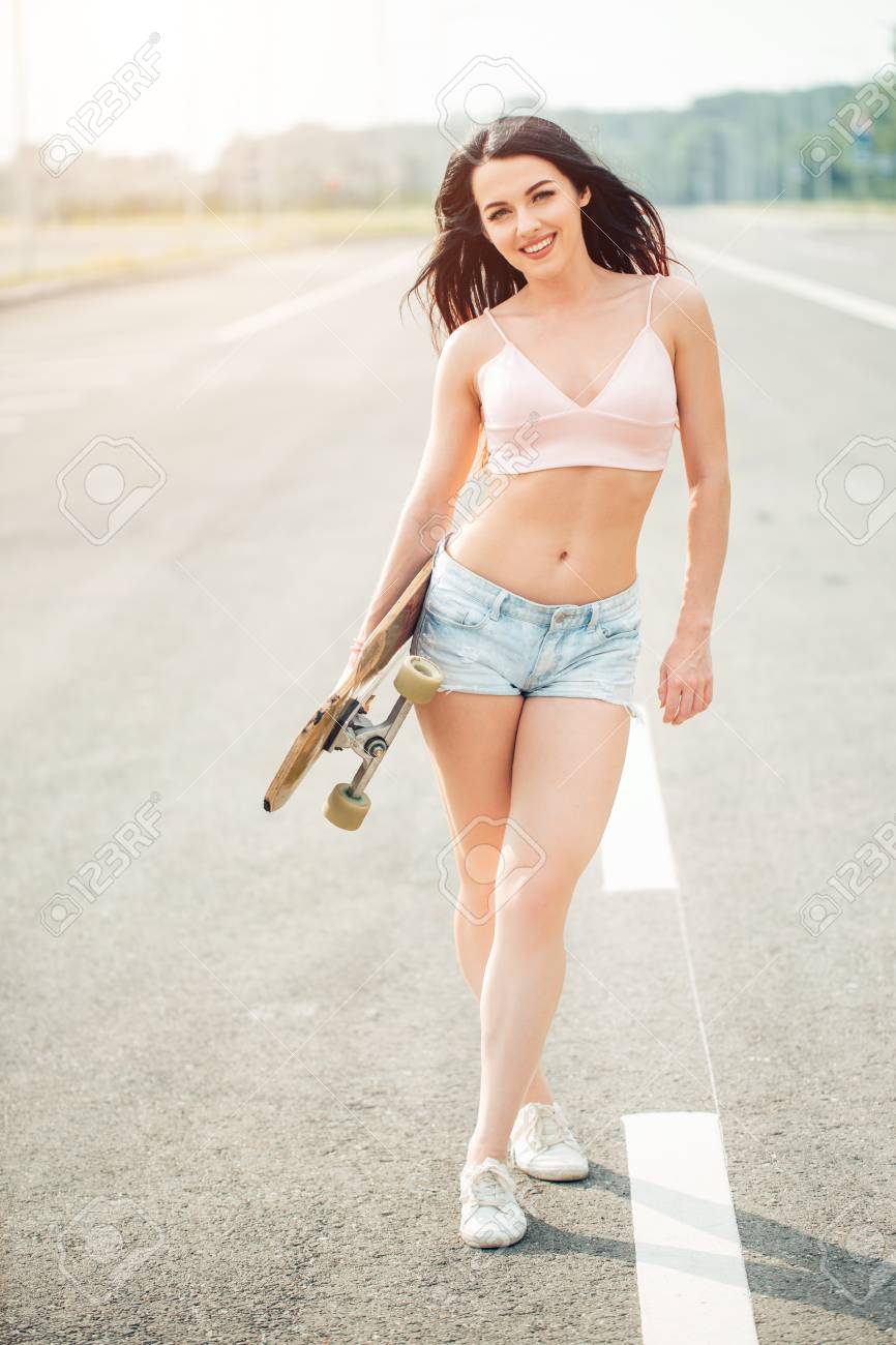 Beautiful Sexy Young Girl In Short Shorts Stand With Longboard In ...