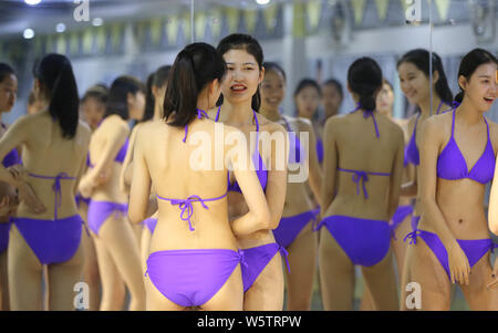 Bikini-clad young female Chinese students take part in a model ...