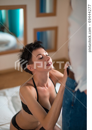 Emotional sexy scene young woman undressing her... - Stock Photo ...