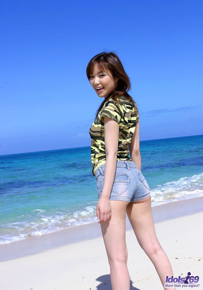 Petite Japanese girl with tiny shorts strips naked on the beach ...