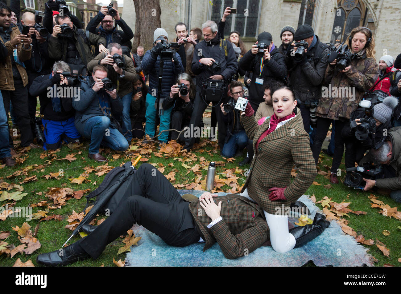 London, UK. 12 December 2014. A couple demonstrates face-sitting ...