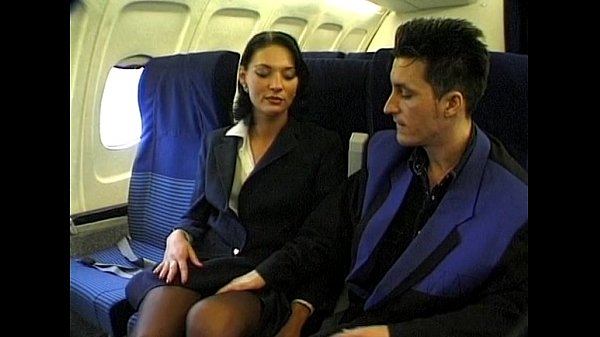 Brunette beauty wearing stewardess uniform gets fucked on a plane ...