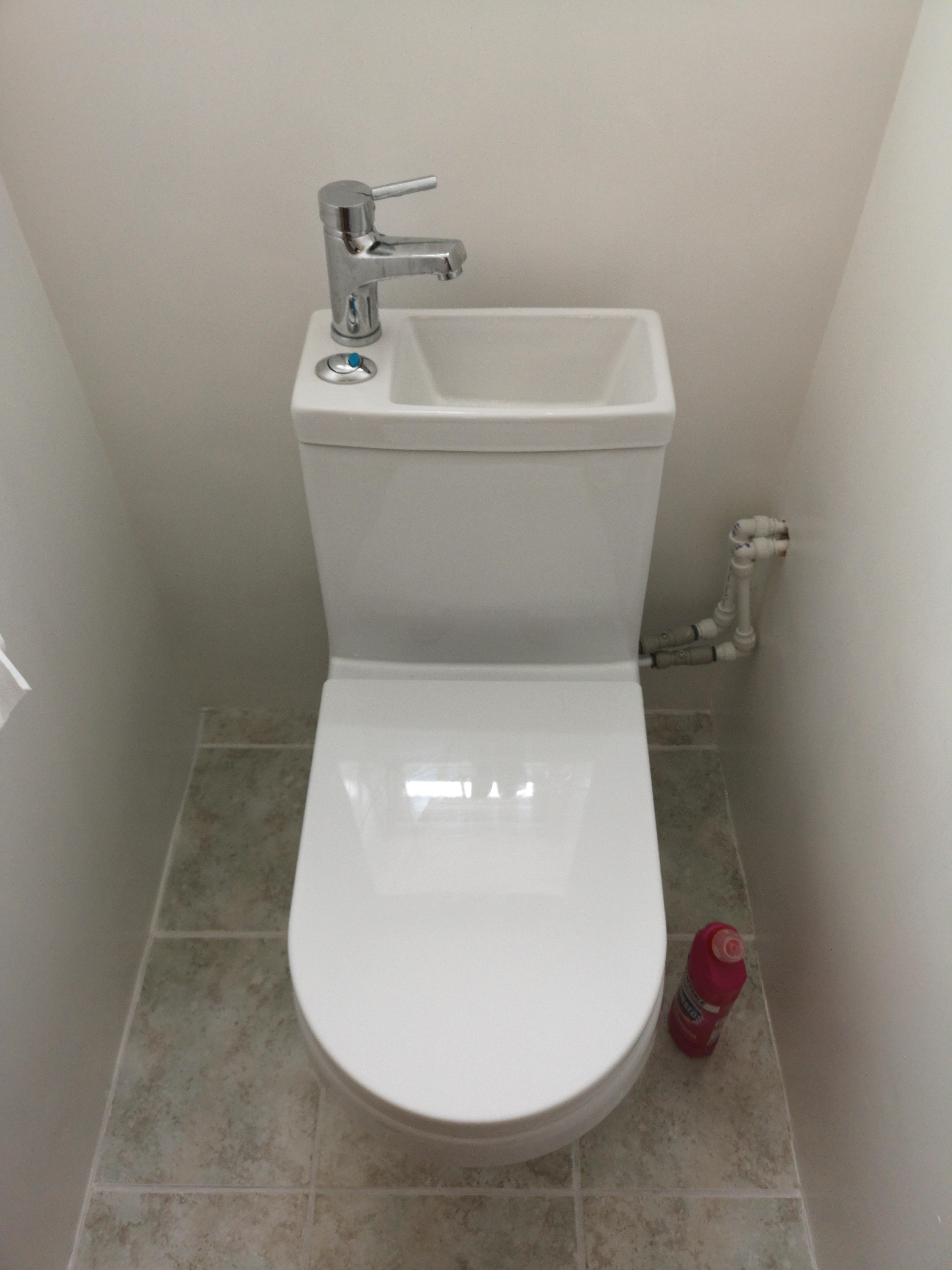 My sister's toilet with a built in hand basin - it uses the waste ...