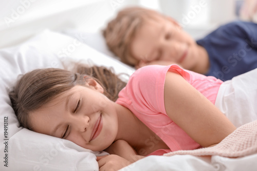 Cute little brother and sister sleeping in bed at home Stock Photo ...