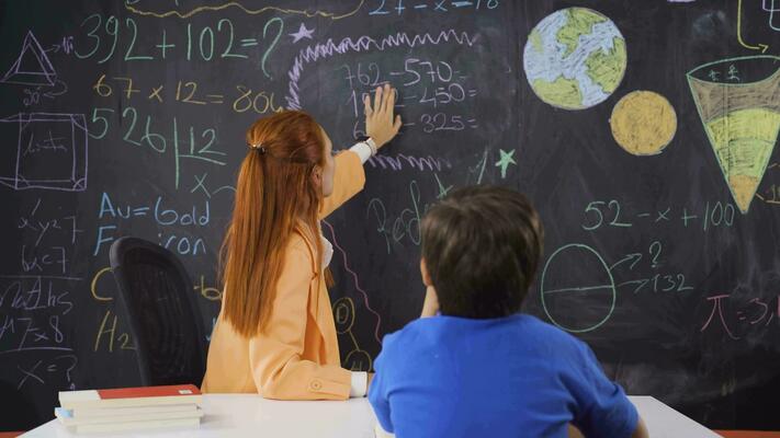 A teacher teaching subtraction to a boy student. 32331851 Stock ...