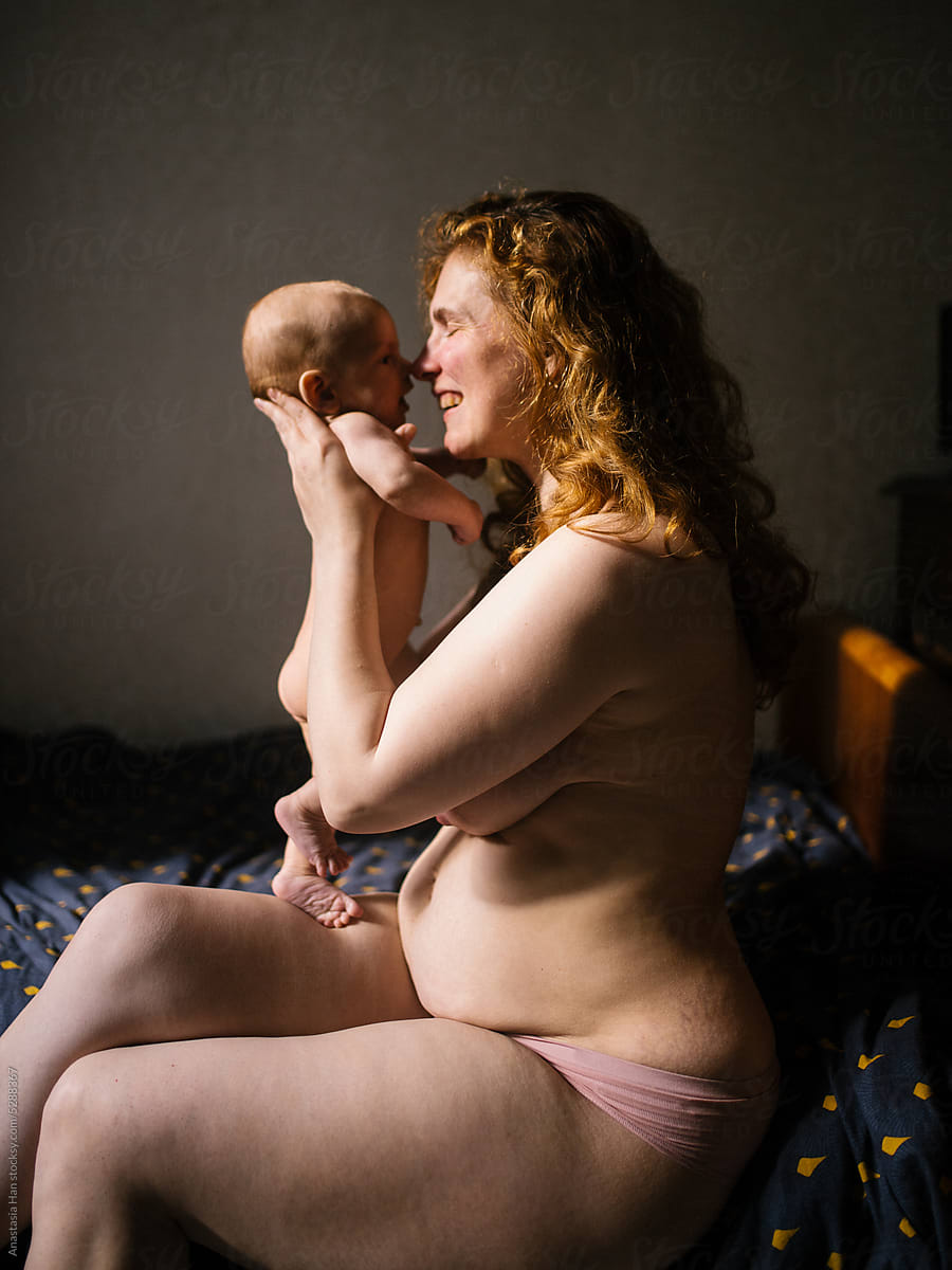 Naked Mom And Her Nude Newborn Son Sitting In Bed