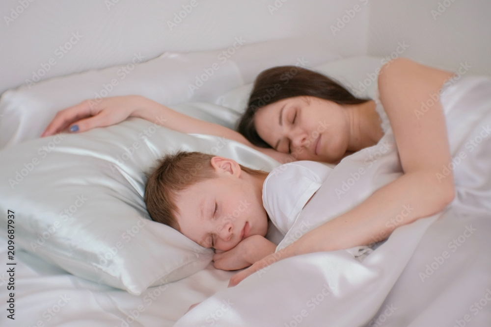 Mom and son sleeping together. Mom hugging her son. Stock Photo ...